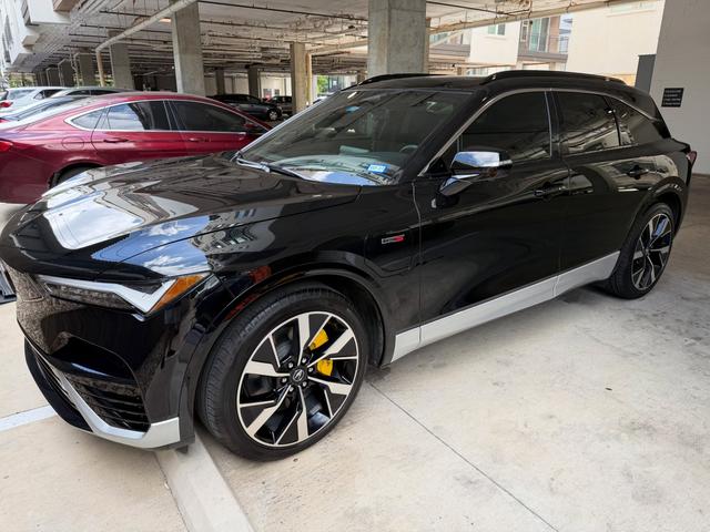 Black Acura ZDX electric SUV after a Gold detail in Austin, with glossy paint and yellow brake calipers