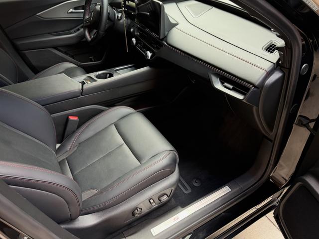 Passenger side of the ZDX cabin after cleaning, with conditioned leather, a wiped-down console, and fresh floor carpet