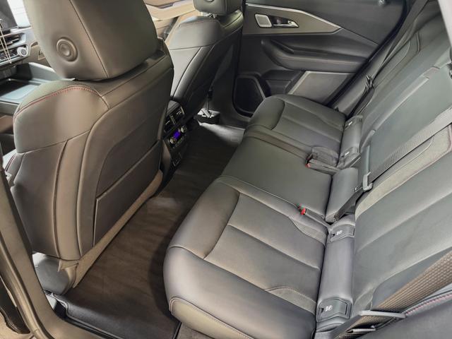Rear seat of the Acura ZDX from the side door after the detail, with conditioned leather and clean carpet