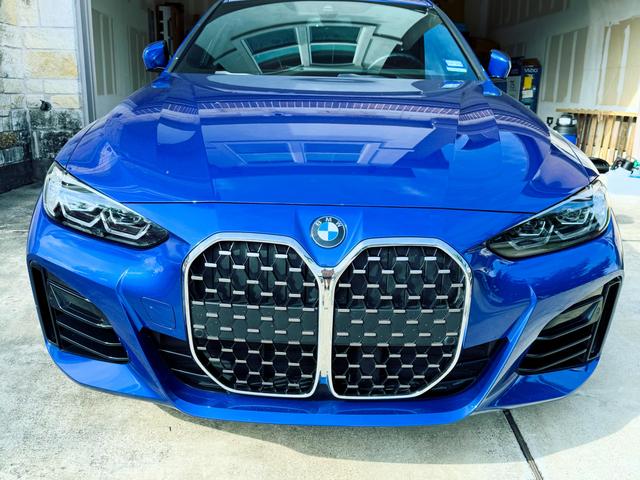 BMW 430i front end with a clean kidney grille and glossy, ceramic-sealed blue paint
