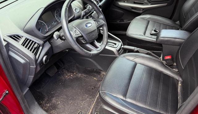 Before: the EcoSport driver footwell with dirt and pet hair packed into the carpet