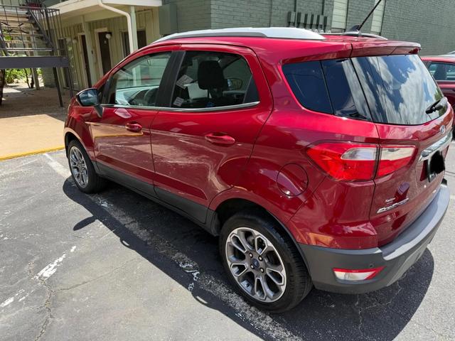 Rear three-quarter view of the EcoSport after the wash, showing clean glass and polished red paint