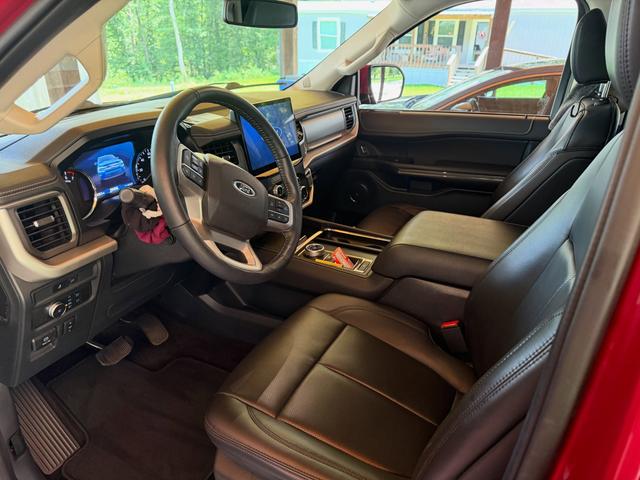 Clean driver seat and dashboard inside the red Ford Expedition after the Silver detail