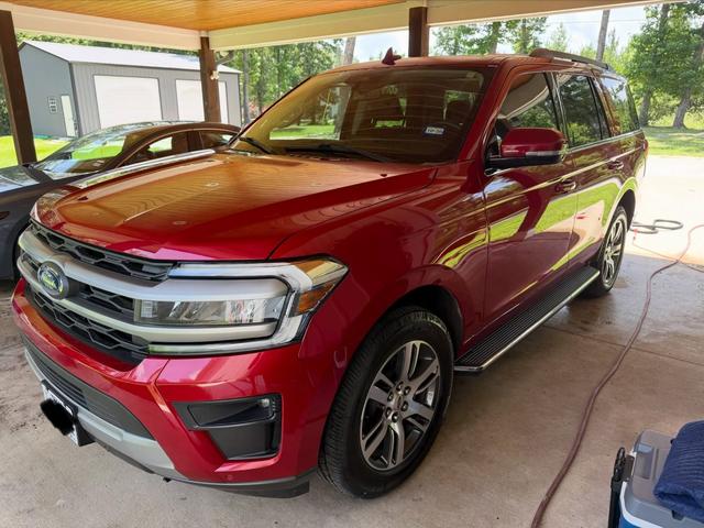 Red Ford Expedition under a carport after a Silver hand wash detail, with glossy paint and a chrome grille