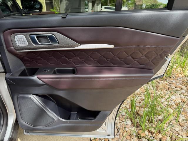 Quilted brown leather rear door panel of the Explorer Platinum after cleaning, with a wiped-out door pocket