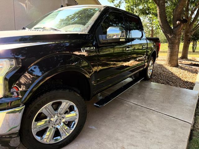 Black Ford F-150 front fender and chrome wheel after a Gold detail in Georgetown
