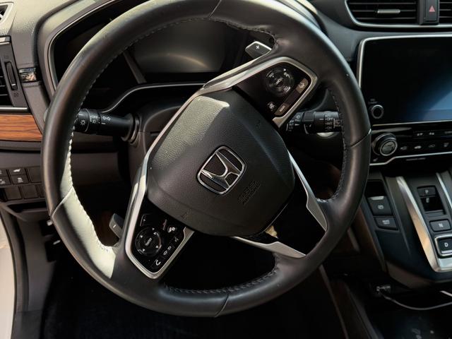 Close view of the CR-V steering wheel and instrument cluster after the interior detail, with clean leather and controls