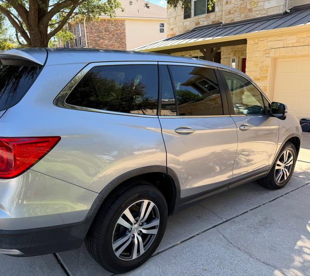 Passenger side of the silver Honda Pilot after the wash, showing glossy doors, clean glass, and dressed tires