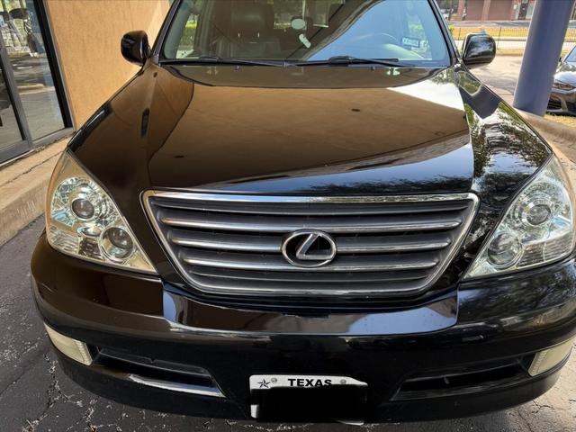 Clean chrome grille and clear headlights on the black Lexus GX470