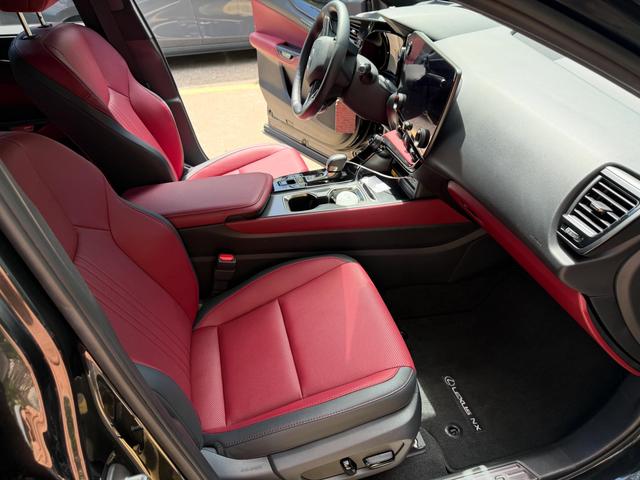 Red leather passenger seat and clean dash inside the Lexus NX 350 after the detail