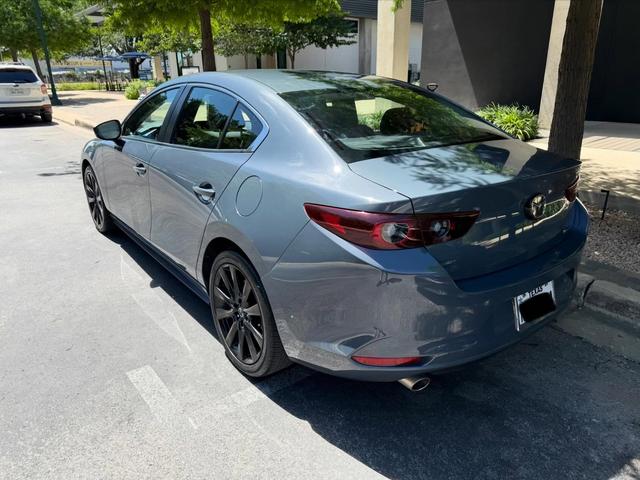 Back of the Mazda 3 Carbon Edition after the wash, with spotless red taillights and a clean rear bumper
