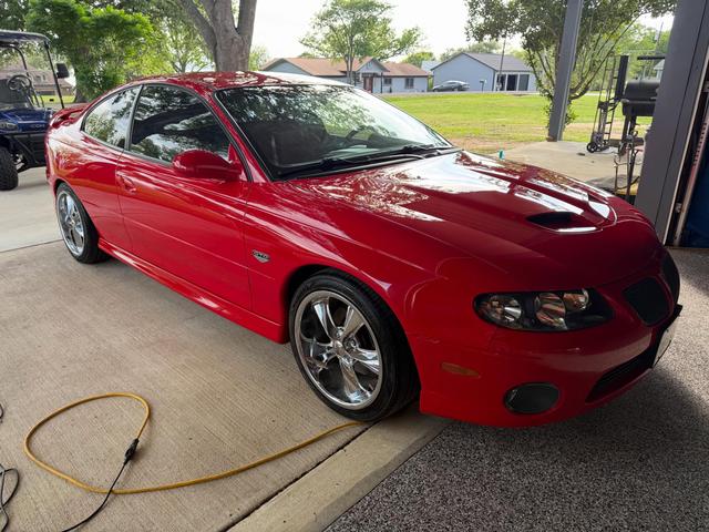 Red 2006 Pontiac GTO coupe after a Silver mobile detail