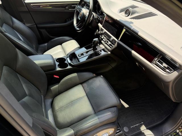 Passenger side of the Macan cabin after cleaning, with two-tone leather seats and a wiped-down center console
