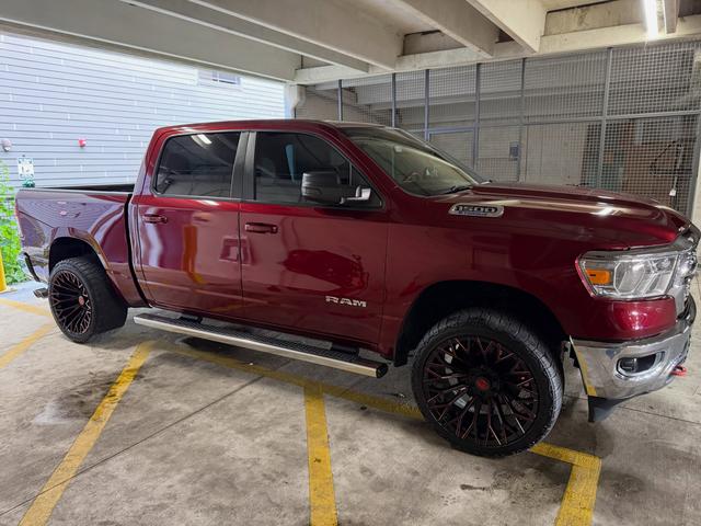 Passenger side three-quarter view of the red Ram 1500 Lone Star after the detail, with clean chrome and paint