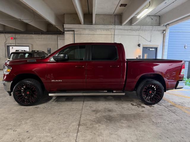 Side profile of the red Ram 1500 crew cab after the hand wash, with glossy paint and black and red wheels