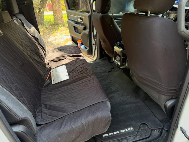 Rear bench of the Ram 1500 with a quilted seat cover and Ram floor mat, vacuumed during the Silver detail