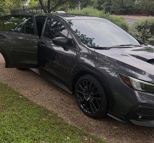 Gray 2025 Subaru WRX after a hand wash detail, parked in a driveway with glossy paint and black wheels