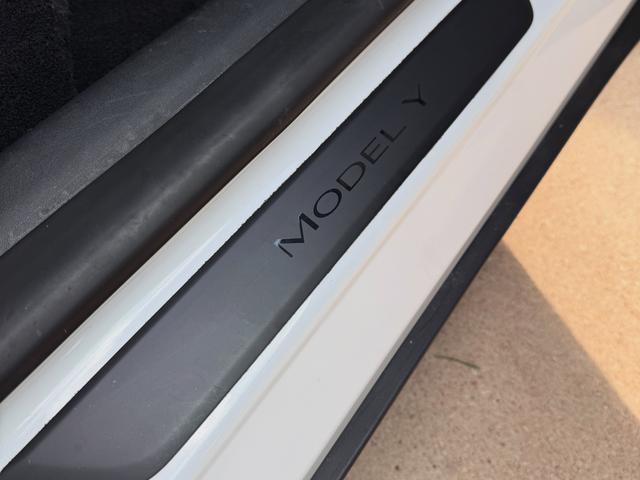 After: clean Model Y door sill plate with clear embossed lettering