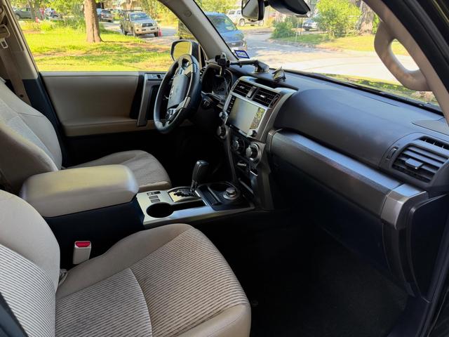 4Runner passenger seat, center console, and dashboard after cleaning, with vacuumed tan upholstery and clear glass