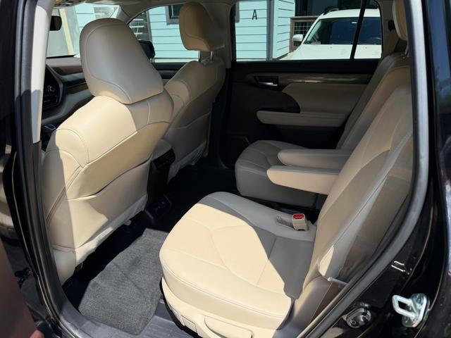 Cream leather front seats of the Highlander seen from the rear door, cleaned and free of dust and crumbs