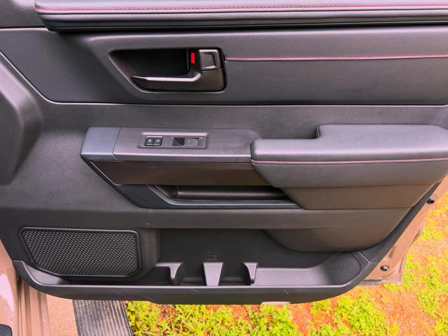 Close-up of a Tundra TRD Pro door panel after cleaning, with red-stitched trim and an empty, wiped-out door pocket