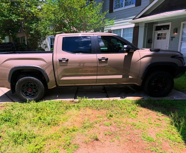 Glossy tan paint along the side of the 2025 Toyota Tundra TRD Pro after its Gold detail